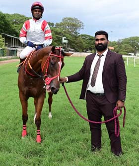 Gold Kite (Dharshan Antony B up), winner of the AMBA VILAS PALACE TROPHY being led in by trainer Aditya K on Wednesday races at Mysore.